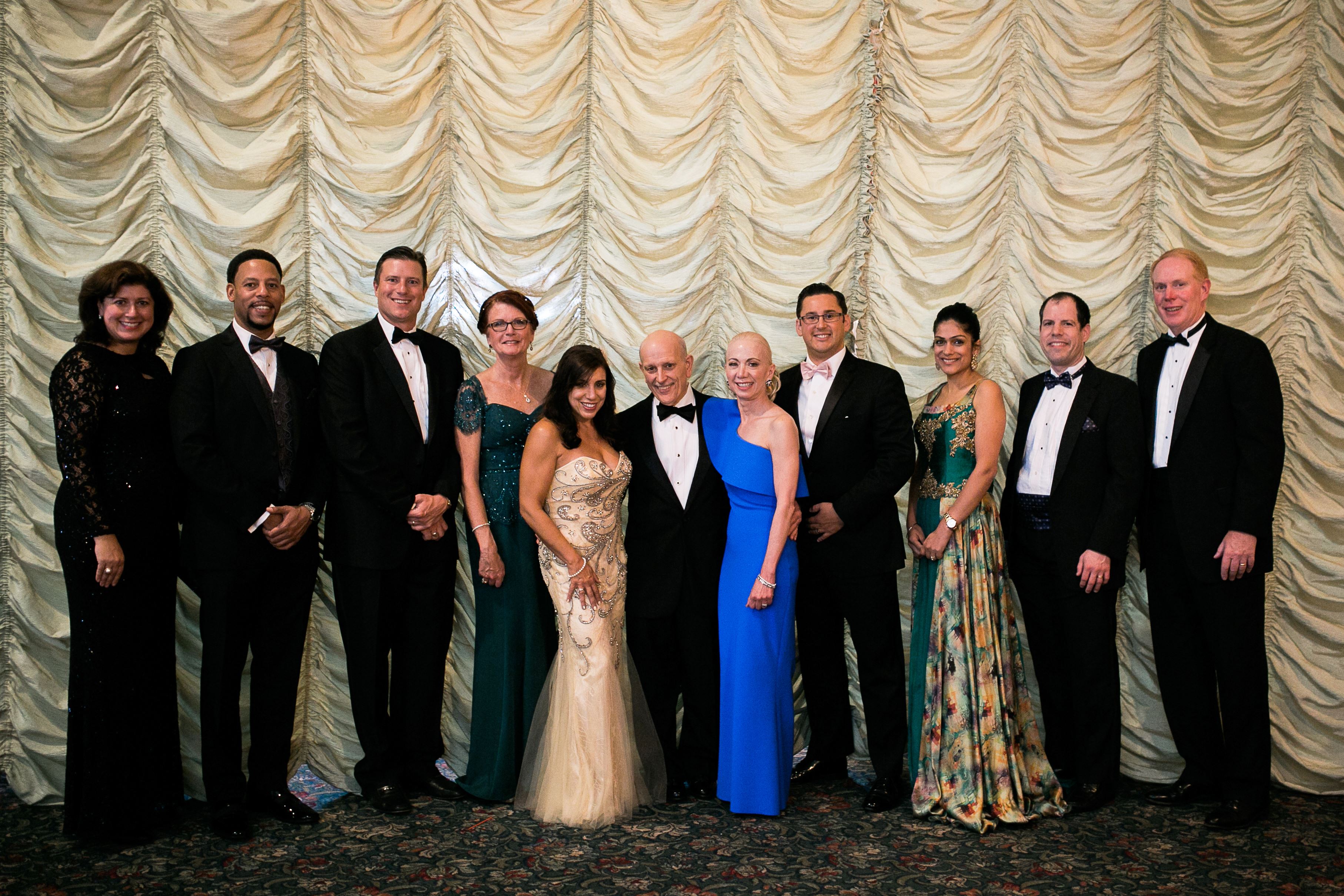 group of people dressed up for gala