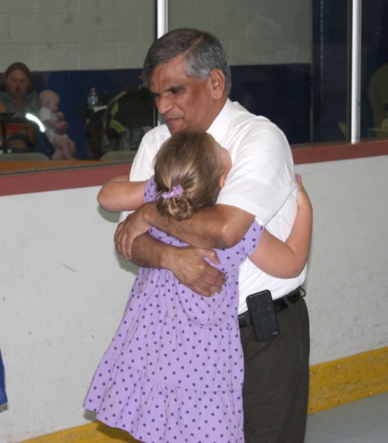 Dr. KP shares a hug with 4-year-old Olivia Jersey, a former NICU patient.